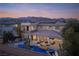 Beautiful aerial view of a luxury home, featuring a custom pool, covered patio, and mountain views at 80 Glade Hollow Dr, Las Vegas, NV 89135