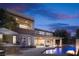 Luxury two-story home featuring a backyard oasis with a pool and an outdoor kitchen at 80 Glade Hollow Dr, Las Vegas, NV 89135