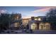 Contemporary home with a modern design, desert landscaping, and a three-car garage with glass doors at 80 Glade Hollow Dr, Las Vegas, NV 89135