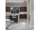 Modern kitchen with dark cabinets, white countertops, stainless steel appliances, and marble flooring at 80 Glade Hollow Dr, Las Vegas, NV 89135