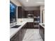 Sleek kitchen featuring dark wood cabinetry, stainless steel appliances, and light countertops at 80 Glade Hollow Dr, Las Vegas, NV 89135