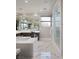 Spa-like main bathroom with marble flooring, a large soaking tub, and a glass-enclosed shower at 80 Glade Hollow Dr, Las Vegas, NV 89135
