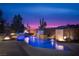 A tranquil pool area at dusk with fire features and minimalist landscaping creates a peaceful retreat at 80 Glade Hollow Dr, Las Vegas, NV 89135
