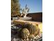A close-up of desert-themed landscaping near a pool with a modern water feature enhances the natural beauty at 80 Glade Hollow Dr, Las Vegas, NV 89135