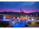 Inviting pool with water features, illuminated at night with colorful sunset skies in the background at 80 Glade Hollow Dr, Las Vegas, NV 89135
