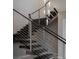 Modern staircase with metal railings and unique lighting fixtures at 80 Glade Hollow Dr, Las Vegas, NV 89135