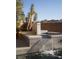 Modern water feature with tiered waterfalls and desert landscaping complements the backyard's tranquil ambiance at 80 Glade Hollow Dr, Las Vegas, NV 89135