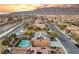 Panoramic aerial shot showcasing a house with a pool, solar panels, and a scenic neighborhood with mountain backdrop at 8115 Cowboy Springs St, North Las Vegas, NV 89085