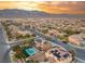 Aerial view of neighborhood featuring a pool and solar panels with mountains in the background at 8115 Cowboy Springs St, North Las Vegas, NV 89085