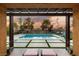 View of the backyard and inground pool from the outdoor covered patio area at 8115 Cowboy Springs St, North Las Vegas, NV 89085