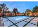 Stunning backyard at dusk, featuring a sparkling pool, ambient string lights, and beautifully landscaped surroundings at 8115 Cowboy Springs St, North Las Vegas, NV 89085