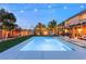Captivating backyard at twilight showcasing a refreshing pool, stylish lounge area, and enchanting string lights at 8115 Cowboy Springs St, North Las Vegas, NV 89085