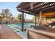 This backyard features an inground pool and an outdoor covered patio area at 8115 Cowboy Springs St, North Las Vegas, NV 89085