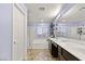 Bright bathroom featuring a double vanity, soaking tub, and glass-enclosed shower at 8115 Cowboy Springs St, North Las Vegas, NV 89085