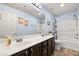 Lovely bathroom featuring double sinks, updated fixtures, and a combined shower and tub at 8115 Cowboy Springs St, North Las Vegas, NV 89085
