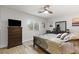 This comfortable bedroom features a ceiling fan and a window to the outside at 8115 Cowboy Springs St, North Las Vegas, NV 89085
