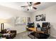 Inviting room with a ceiling fan, workspace, natural light, and relaxing decor at 8115 Cowboy Springs St, North Las Vegas, NV 89085