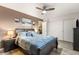 This spacious bedroom features a large bed, closet and an adjacent bedroom door at 8115 Cowboy Springs St, North Las Vegas, NV 89085