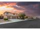 Beautiful two-story home featuring a three-car garage, well-manicured landscaping, and a charming facade at sunset at 8115 Cowboy Springs St, North Las Vegas, NV 89085
