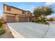 Beautiful two-story home with three-car garage, a well-kept yard, and manicured landscaping at 8115 Cowboy Springs St, North Las Vegas, NV 89085