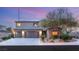 Inviting two-story home with a three-car garage, stone accents, and lush landscaping, creating curb appeal at 8115 Cowboy Springs St, North Las Vegas, NV 89085