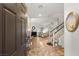Inviting foyer with tile flooring, staircase, and an open view of the living and dining areas at 8115 Cowboy Springs St, North Las Vegas, NV 89085