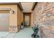 Inviting front entrance with a desert-themed door and tasteful stonework accents and xeriscaping at 8115 Cowboy Springs St, North Las Vegas, NV 89085