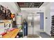 This well-lit garage includes storage and an adjacent full sized refrigerator at 8115 Cowboy Springs St, North Las Vegas, NV 89085
