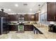 Modern kitchen with stainless steel appliances, granite countertops, and dark cabinetry at 8115 Cowboy Springs St, North Las Vegas, NV 89085