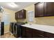Functional laundry room with washer, dryer, sink, countertop, and dark cabinets at 8115 Cowboy Springs St, North Las Vegas, NV 89085