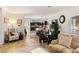Open-concept living and dining area with dark wood kitchen in the background and neutral decor throughout at 8115 Cowboy Springs St, North Las Vegas, NV 89085