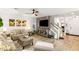 Cozy living room featuring modern decor, a ceiling fan, and natural light at 8115 Cowboy Springs St, North Las Vegas, NV 89085
