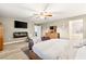 Serene main bedroom featuring a fireplace, TV, sitting area, and en-suite bathroom access at 8115 Cowboy Springs St, North Las Vegas, NV 89085