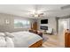 Bright main bedroom with TV, fireplace and laminate floors at 8115 Cowboy Springs St, North Las Vegas, NV 89085