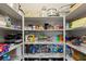 Well-stocked pantry featuring marble shelving with a variety of food and kitchen supplies at 8115 Cowboy Springs St, North Las Vegas, NV 89085