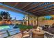Cozy patio with firepit, outdoor furniture, and string lights, perfect for evening gatherings at 8115 Cowboy Springs St, North Las Vegas, NV 89085