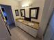 Bathroom with a granite countertop vanity, double sinks, and tiled flooring at 8401 Luna Bay Ln, Las Vegas, NV 89128