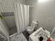 Clean bathroom with white tiled shower featuring mosaic accents, and a modern toilet with sink at 8401 Luna Bay Ln, Las Vegas, NV 89128