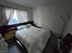 Bedroom featuring a bed, large window, and ample closet space at 8401 Luna Bay Ln, Las Vegas, NV 89128