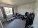 Bedroom with a bed, game chair, and natural lighting through a large window at 8401 Luna Bay Ln, Las Vegas, NV 89128