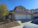 Lovely two-story home with a three-car garage, desert landscaping, and inviting curb appeal at 8401 Luna Bay Ln, Las Vegas, NV 89128