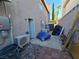 The home's exterior reveals an area with storage, utilities, and general clutter requiring cleanup and organization at 8401 Luna Bay Ln, Las Vegas, NV 89128