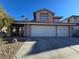 Charming two-story home featuring a three-car garage, desert landscaping, and a well-maintained front yard at 8401 Luna Bay Ln, Las Vegas, NV 89128