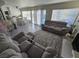Cozy living room featuring a fireplace, view to the pool, kitchen, and dining area at 8401 Luna Bay Ln, Las Vegas, NV 89128