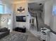 Inviting living room with staircase, neutral tones, and an entertainment center at 8401 Luna Bay Ln, Las Vegas, NV 89128