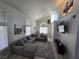 Spacious living room with vaulted ceilings, large windows, and a comfortable sectional sofa at 8401 Luna Bay Ln, Las Vegas, NV 89128