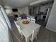 Spacious living area featuring an open-concept kitchen, a dining table, and a cozy fireplace at 8401 Luna Bay Ln, Las Vegas, NV 89128