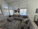 Comfortable living room featuring a large sectional sofa, area rug, and ample natural light at 8401 Luna Bay Ln, Las Vegas, NV 89128