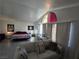 Serene main bedroom with vaulted ceilings, a comfortable seating area, and ample natural light at 8401 Luna Bay Ln, Las Vegas, NV 89128