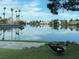 A picturesque pond reflects the surrounding palms and houses, enhanced by wildlife and a walking path at 8401 Luna Bay Ln, Las Vegas, NV 89128